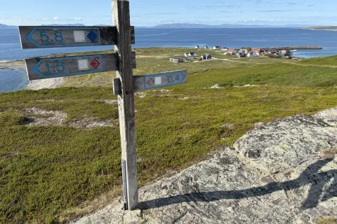 Signpost with distances on Ekkerøya, looking out over the village and the fjord
