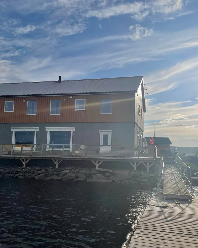 Jakobselvkaia gjestehus sett fra sjøsiden en solfylt dag