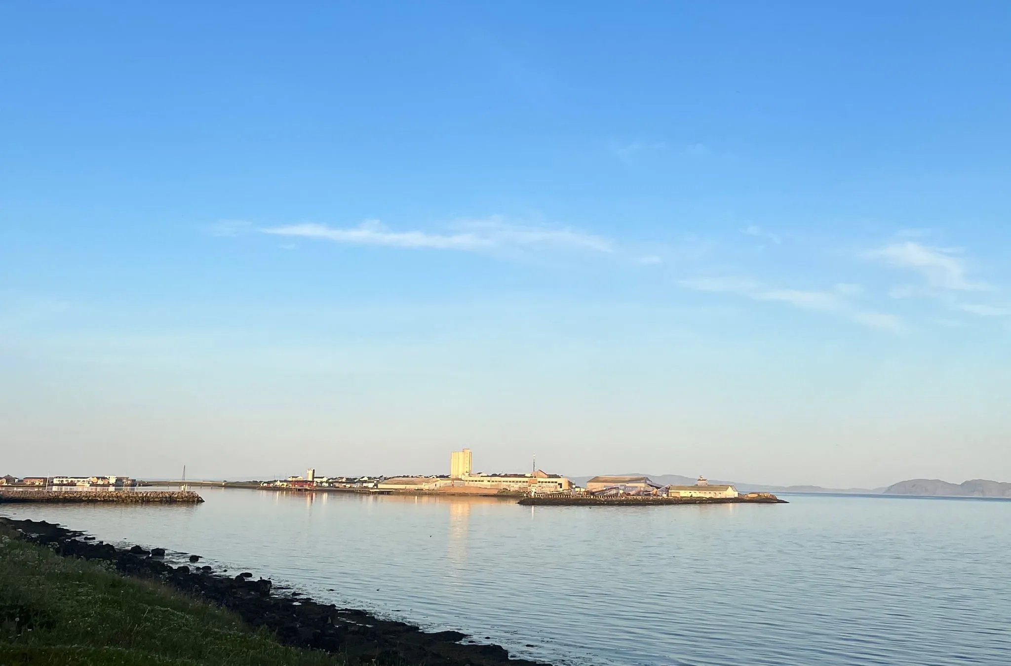 Calm fjord and the harbour in Vadsø on a summer evening